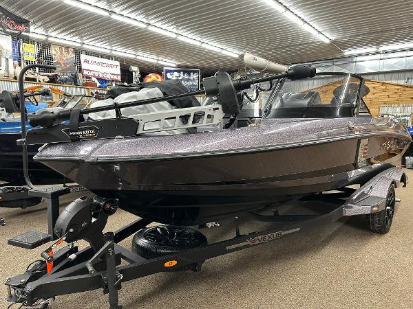 Slide: The Image of 2024 Vexus DVX19S boat on display in a showroom. - 1