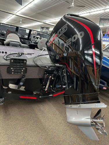 Slide: The Image of 2024 Vexus DVX19S boat with powerful outboard motor in showroom. - 2
