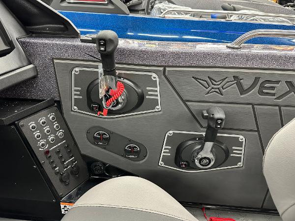 Slide: The Image of 2024 Vexus DVX19S boat control panel with dual throttle levers and instrument gauges. - 6