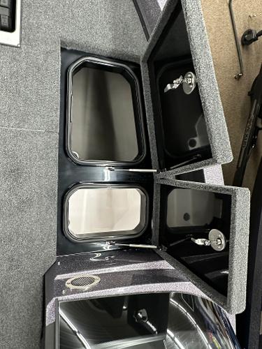 Slide: The Image of 2024 Vexus DVX19S boat storage compartments with open lids. - 8