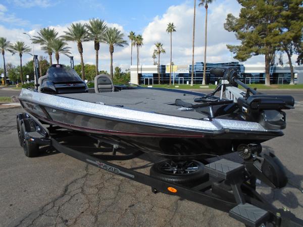 Slide: The Image of 2024 Vexus VX20 boat on trailer with palm trees in the background. - 1