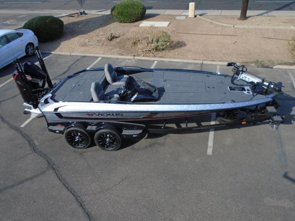 Slide: The Image of 2024 Vexus VX20 bass boat in a parking lot, aerial view. - 2