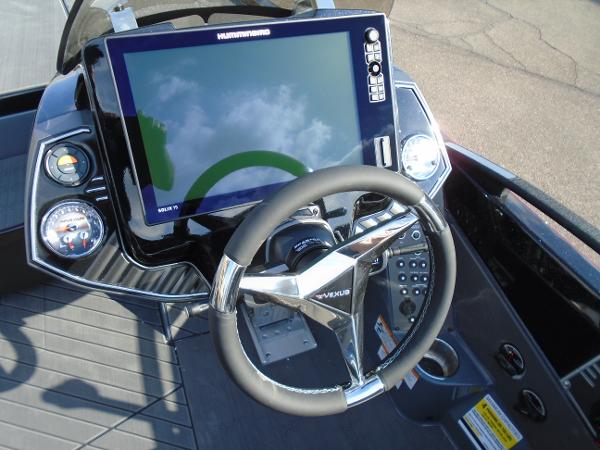 Slide: The Image of 2024 Vexus VX20 boat dashboard with steering wheel and Humminbird display. - 21