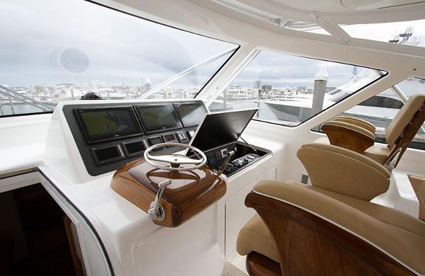 Slide: The Image of Helm station of 2025 Viking 44 Open Express yacht with modern controls and plush seating. - 4