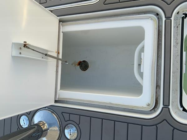 Slide: The Image of Open storage compartment on a 2005 Viking 45 Open Express boat. - 18