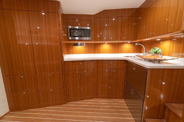 Slide: The Image of 2025 Viking 46 Billfish yacht kitchen with wood cabinetry and modern appliances. - 5