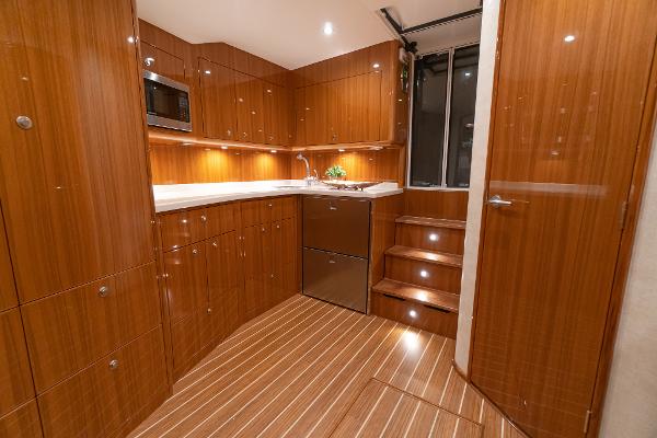 Slide: The Image of Luxurious kitchen interior of 2025 Viking 46 Billfish yacht with wooden cabinetry and modern appliances. - 6