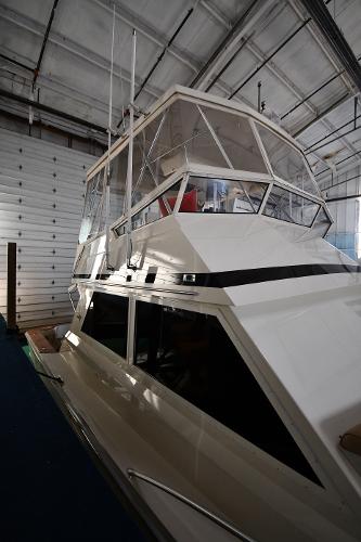 Slide: The Image of 1988 Viking 48 Convertible yacht in a storage facility, showcasing its sleek design. - 1