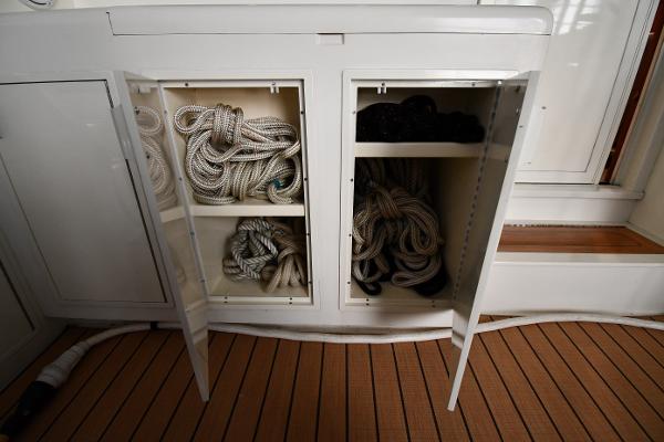 Slide: The Image of Storage compartments with ropes on a 1988 Viking 48 Convertible boat. - 15
