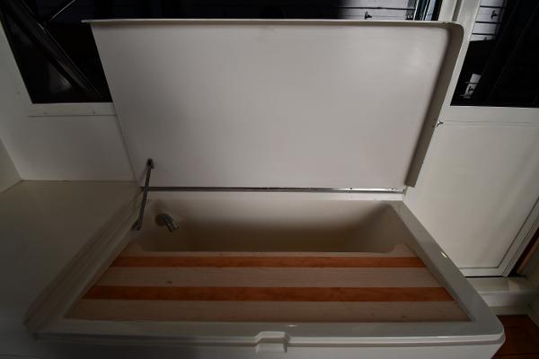 Slide: The Image of Open storage compartment on 1988 Viking 48 Convertible boat. - 17