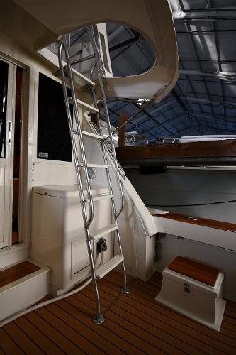Slide: The Image of 1988 Viking 48 Convertible yacht interior with ladder and wooden deck. - 18