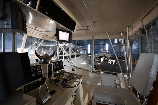 Slide: The Image of Interior of 1988 Viking 48 Convertible yacht with steering wheel and navigation equipment. - 19