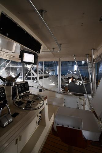 Slide: The Image of Interior view of 1988 Viking 48 Convertible yacht cockpit with steering wheel and controls. - 20