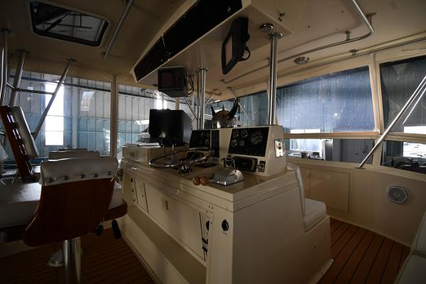 Slide: The Image of 1988 Viking 48 Convertible yacht interior with navigation equipment and wooden flooring. - 21