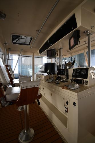 Slide: The Image of Interior of 1988 Viking 48 Convertible yacht, featuring helm controls and seating. - 22
