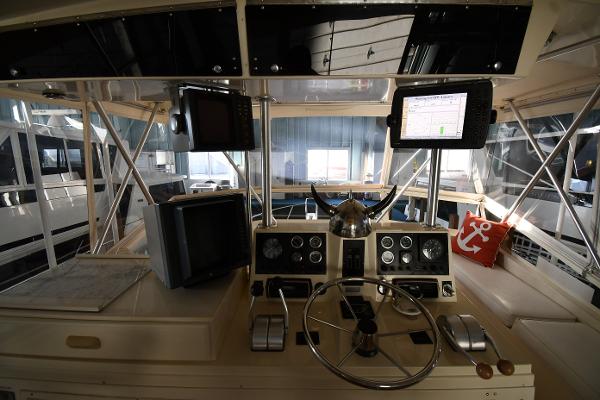 Slide: The Image of 1988 Viking 48 Convertible yacht helm with navigation equipment and steering wheel. - 23