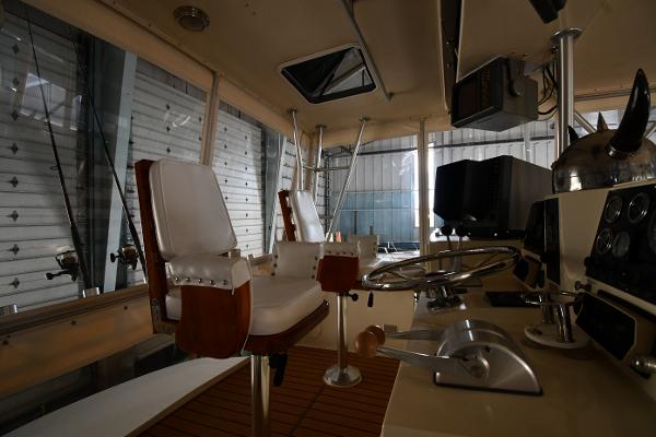 Slide: The Image of Interior of 1988 Viking 48 Convertible yacht with steering wheel and captain's chairs. - 35