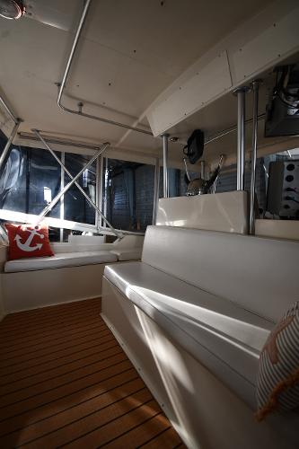 Slide: The Image of 1988 Viking 48 Convertible yacht interior with white seating and wooden flooring. - 40