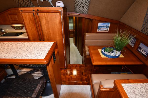 Slide: The Image of Interior of 1988 Viking 48 Convertible yacht with wood finishes and cozy dining area. - 42