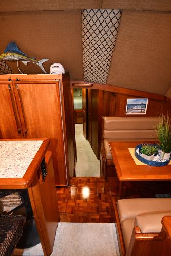 Slide: The Image of 1988 Viking 48 Convertible yacht interior with wood finish and dining area. - 43