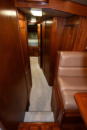Slide: The Image of Interior hallway of 1988 Viking 48 Convertible yacht with wooden paneling and carpet. - 44