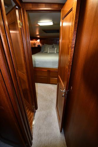 Slide: The Image of Interior of 1988 Viking 48 Convertible yacht, featuring a cozy bedroom with wooden finishes. - 45