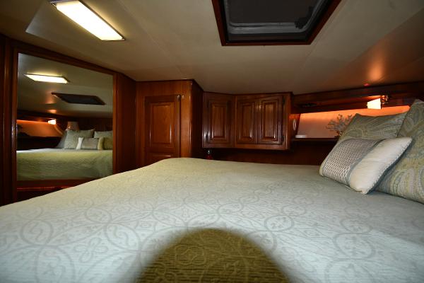 Slide: The Image of Luxurious cabin interior of 1988 Viking 48 Convertible yacht with elegant bedding and wood cabinetry. - 49