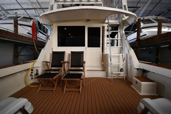 Slide: The Image of 1988 Viking 48 Convertible yacht interior with wooden deck and seating area. - 7