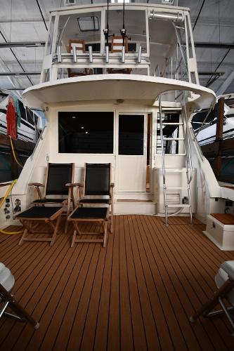 Slide: The Image of 1988 Viking 48 Convertible yacht with wooden deck and seating area. - 8