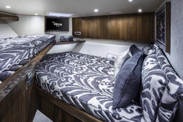 Slide: The Image of Luxurious cabin interior of 2025 Viking 58 Convertible yacht with patterned bedding. - 16