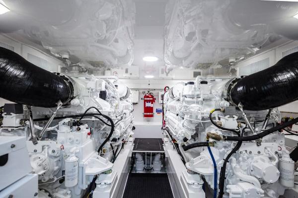 Slide: The Image of Engine room of 2025 Viking 58 Convertible yacht with twin engines and fire extinguisher. - 4