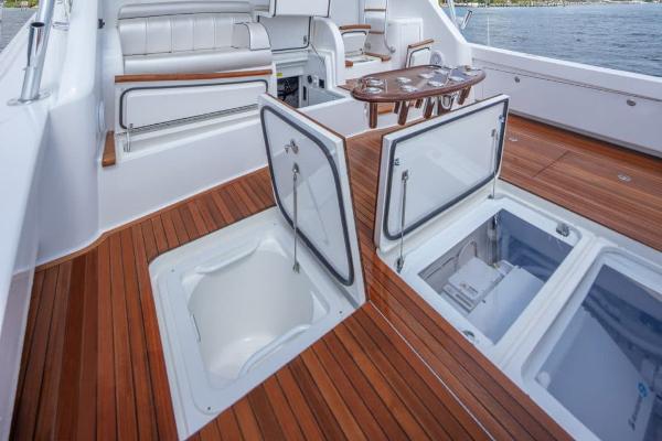Slide: The Image of 2025 Viking 58 Convertible yacht with open storage compartments on teak deck. - 8