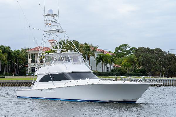 Slide: The Image of 2005 Viking 61 yacht cruising near waterfront homes. - 1