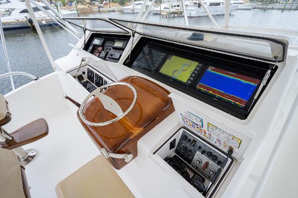 Slide: The Image of 2005 Viking 61 yacht helm with advanced navigation displays and controls. - 12