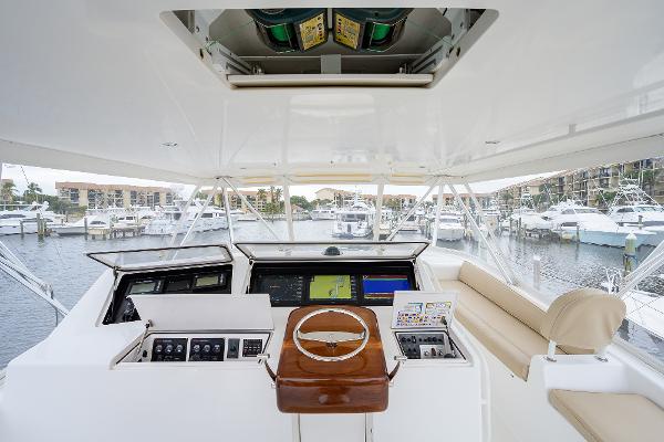 Slide: The Image of 2005 Viking 61 yacht helm with modern navigation equipment and marina view. - 13