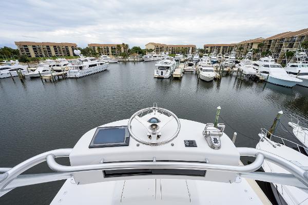 Slide: The Image of View from 2005 Viking 61 yacht helm overlooking marina with multiple boats docked. - 20