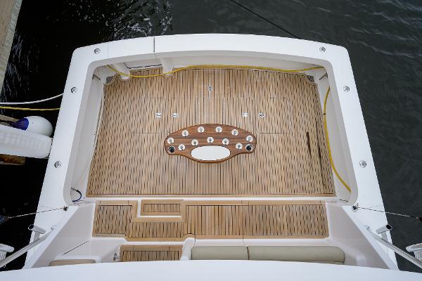 Slide: The Image of Viking 61 yacht deck, 2005 model, featuring teak flooring and fishing rod holders. - 21