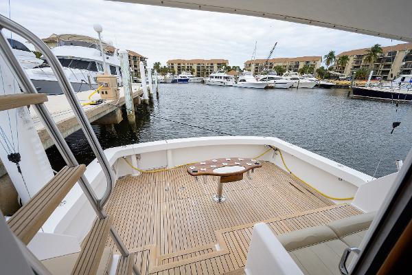 Slide: The Image of 2005 Viking 61 yacht docked at marina, featuring spacious deck and scenic waterfront view. - 22
