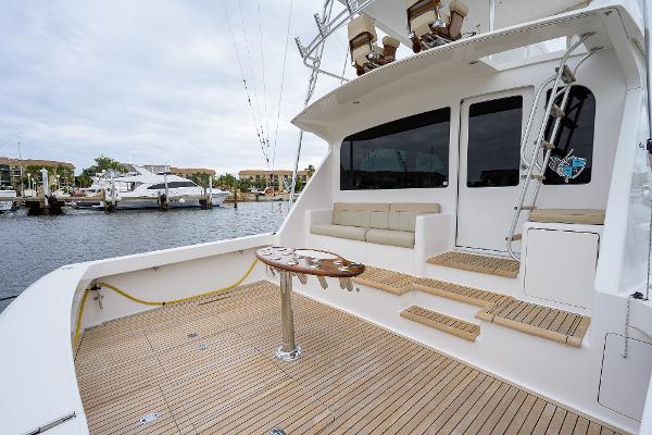 Slide: The Image of 2005 Viking 61 yacht deck with seating and table, docked at marina. - 23