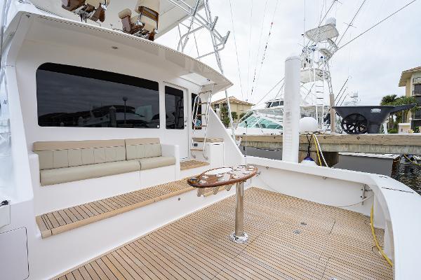 Slide: The Image of 2005 Viking 61 yacht with spacious deck and seating area at marina. - 26