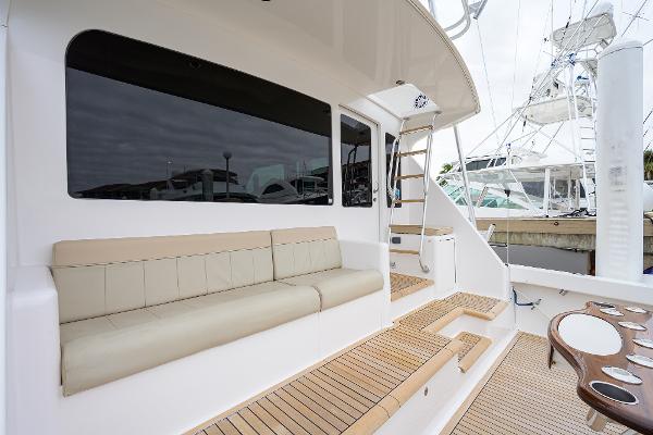 Slide: The Image of 2005 Viking 61 yacht deck with seating and ladder, featuring teak flooring. - 27