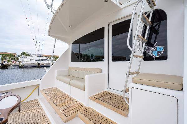Slide: The Image of 2005 Viking 61 yacht deck with seating and ladder, docked at marina. - 28