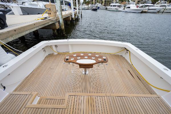 Slide: The Image of 2005 Viking 61 yacht deck with wooden flooring and fishing station at marina. - 29
