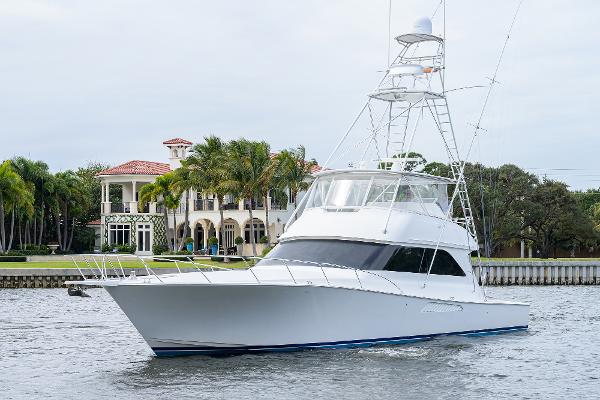 Slide: The Image of 2005 Viking 61 yacht cruising near waterfront mansion. - 3