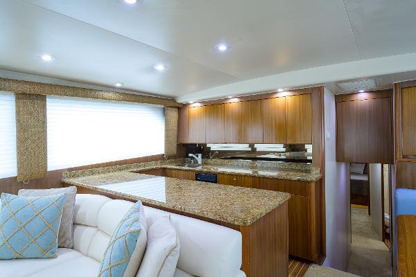 Slide: The Image of Luxurious interior of 2005 Viking 61 yacht with modern kitchen and cozy seating area. - 37