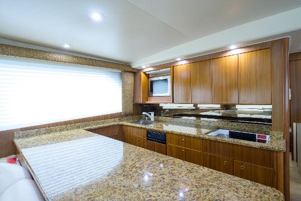 Slide: The Image of Luxurious kitchen interior of 2005 Viking 61 yacht with granite countertops and wooden cabinetry. - 39