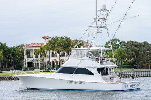 Slide: The Image of 2005 Viking 61 yacht cruising near waterfront mansion. - 4