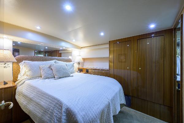 Slide: The Image of Luxurious bedroom interior on 2005 Viking 61 yacht with cozy bedding and wooden accents. - 42