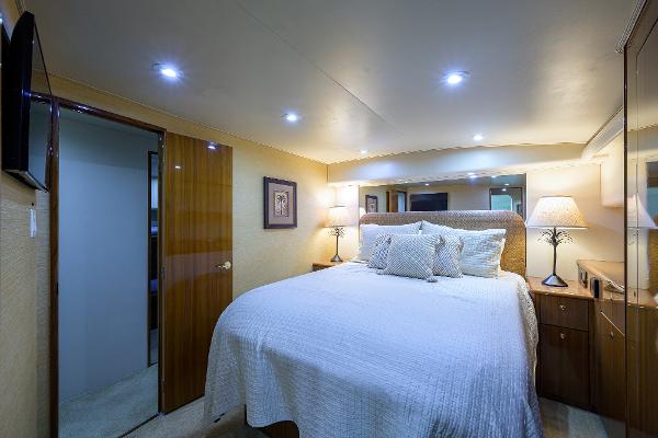 Slide: The Image of Luxurious bedroom interior of 2005 Viking 61 yacht with cozy lighting and elegant decor. - 45