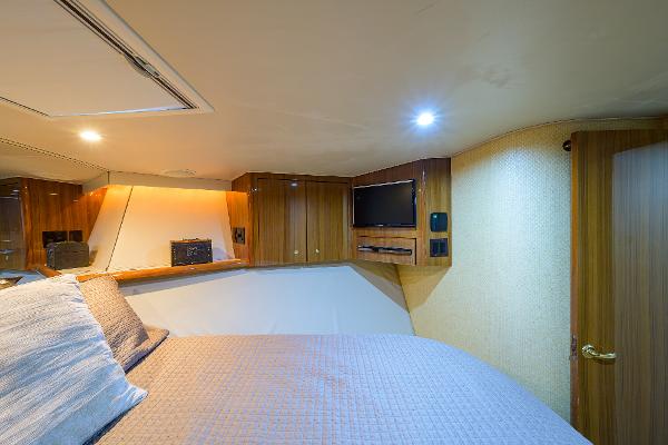 Slide: The Image of Luxurious cabin interior of 2005 Viking 61 yacht with cozy bedding and wooden cabinetry. - 49